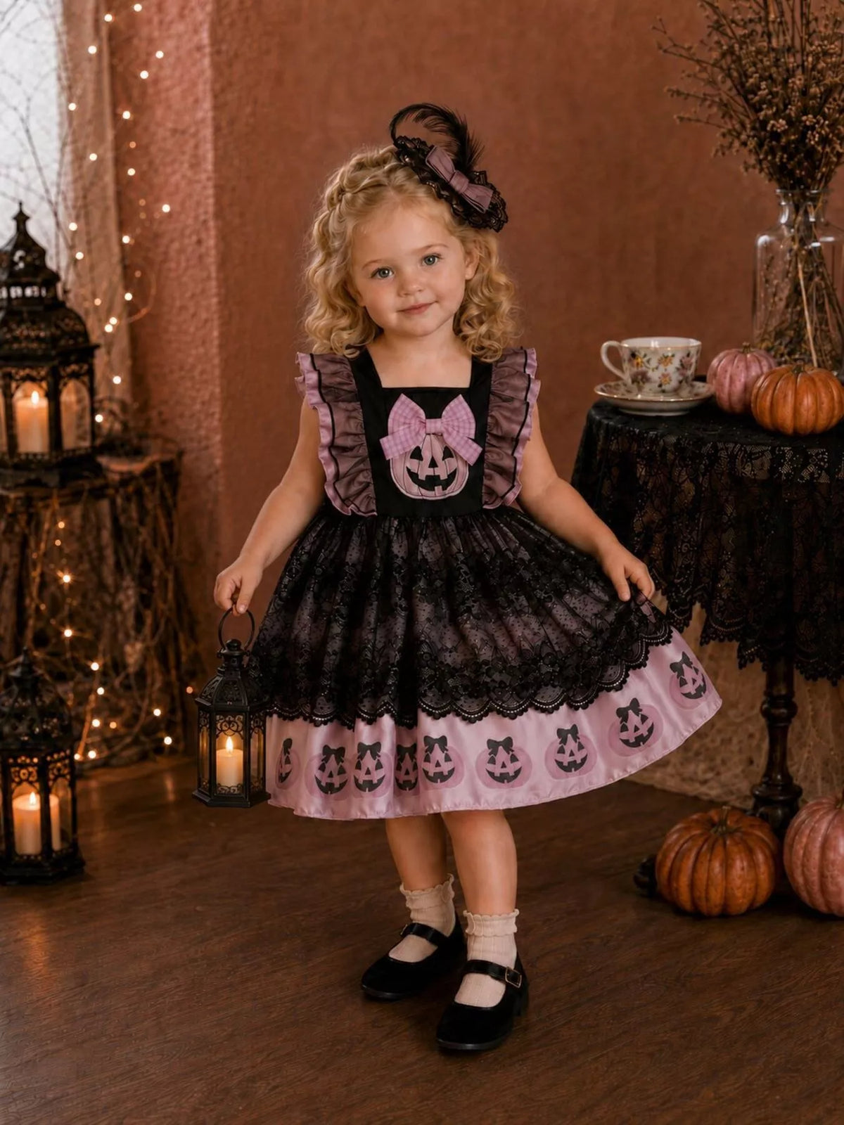 Front view of the child's black-and-pink pumpkin Halloween dress.