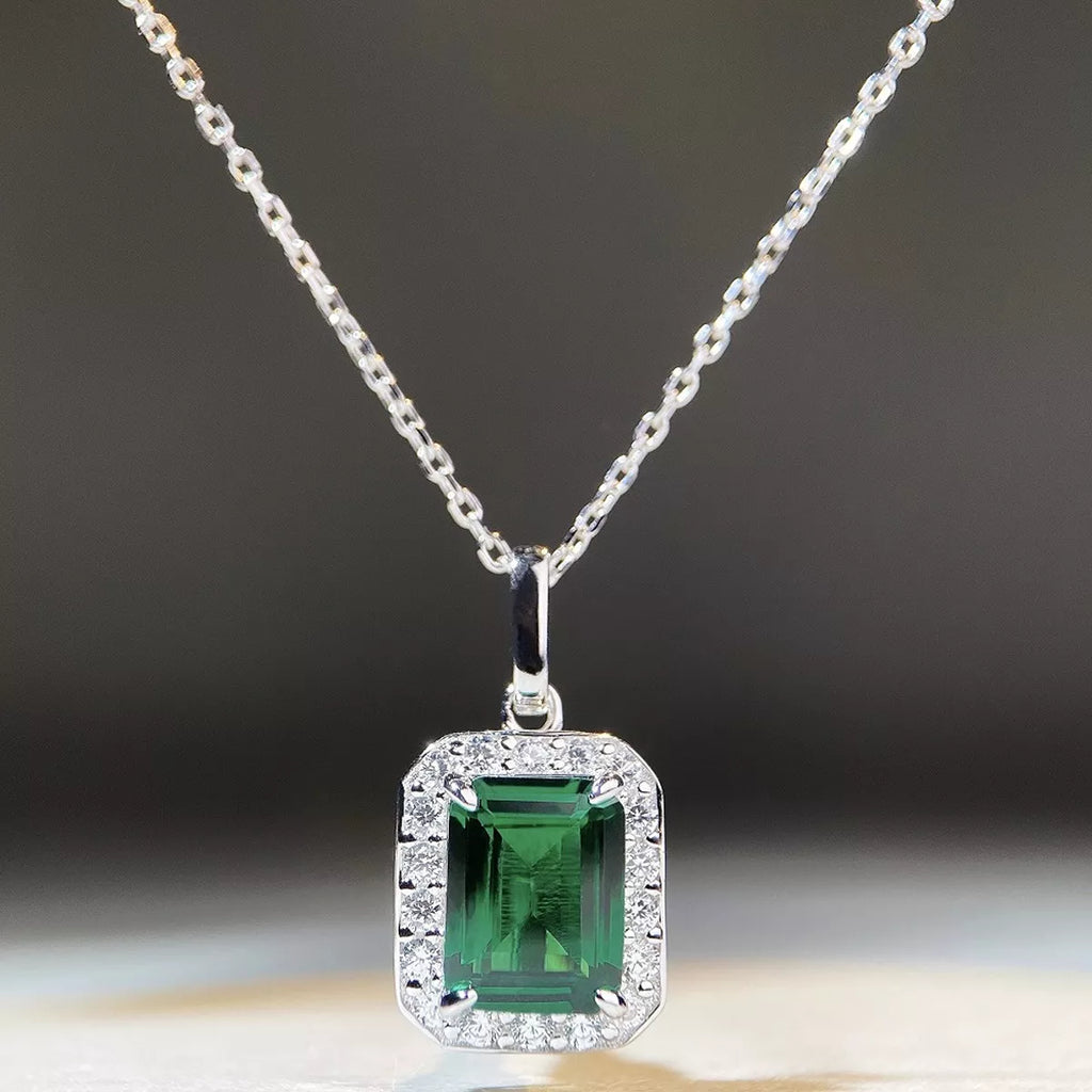 Silver-tone pendant necklace with a green rectangular stone