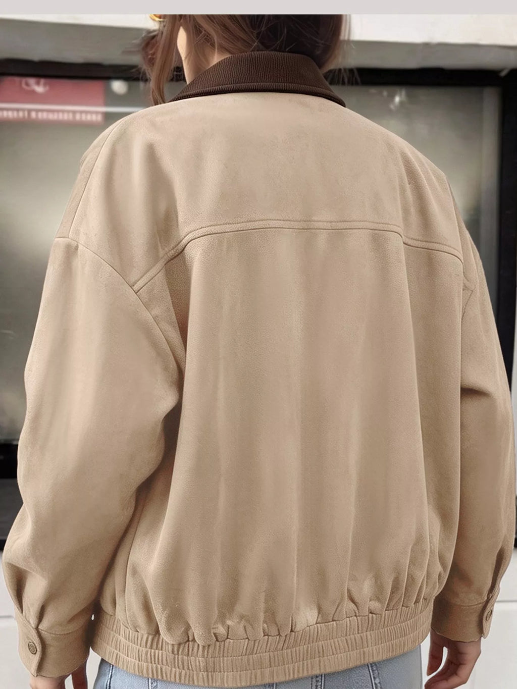 Back view of the apricot jacket with a gathered hem.