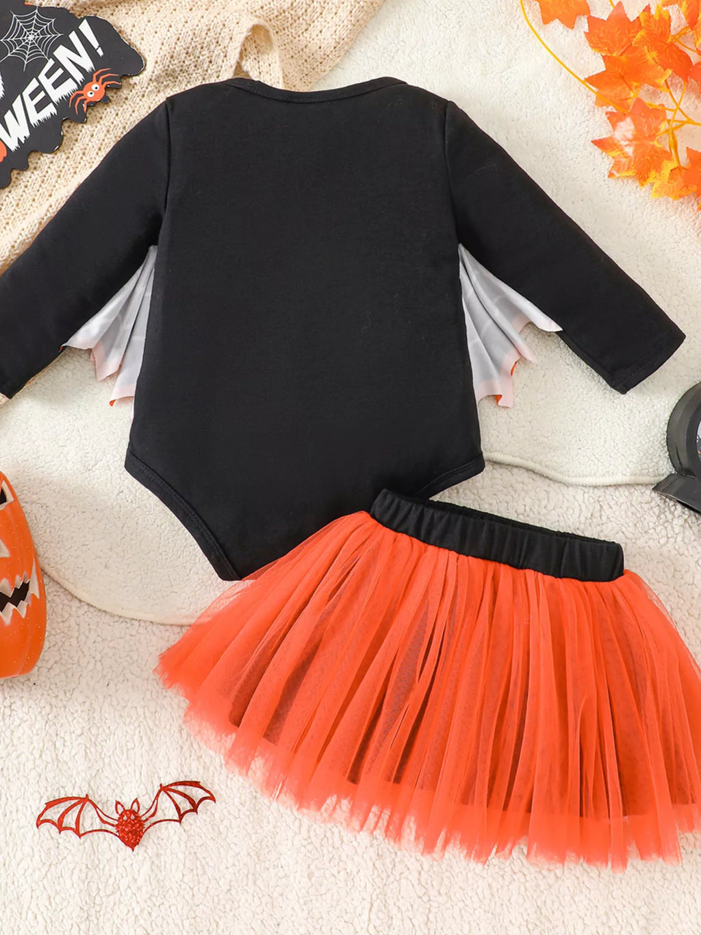 Back flat lay of the black bodysuit with bat wings and orange tulle skirt.