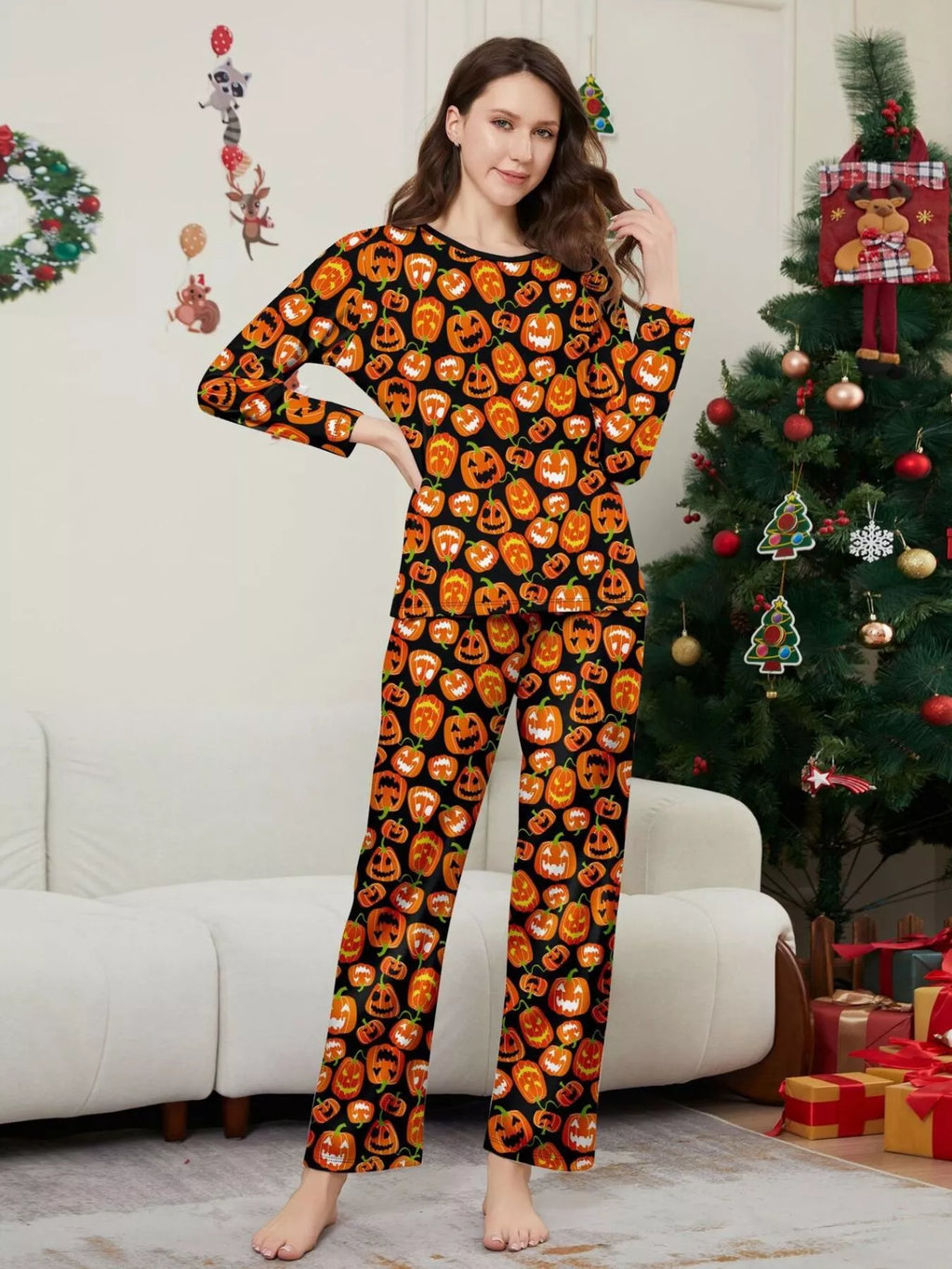 Front view of a woman wearing the allover pumpkin-print pajamas.