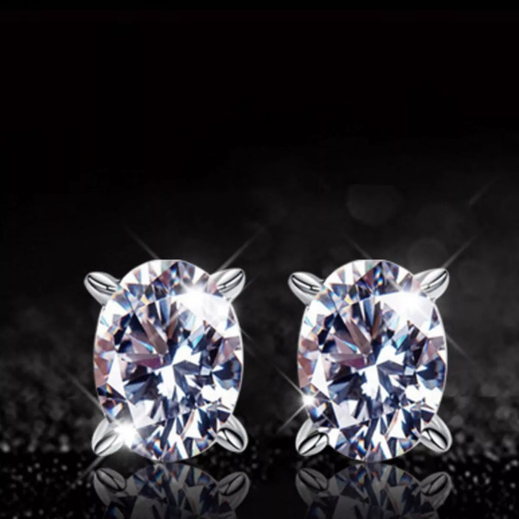 Silver-tone stud earrings with clear faceted stones — detail view
