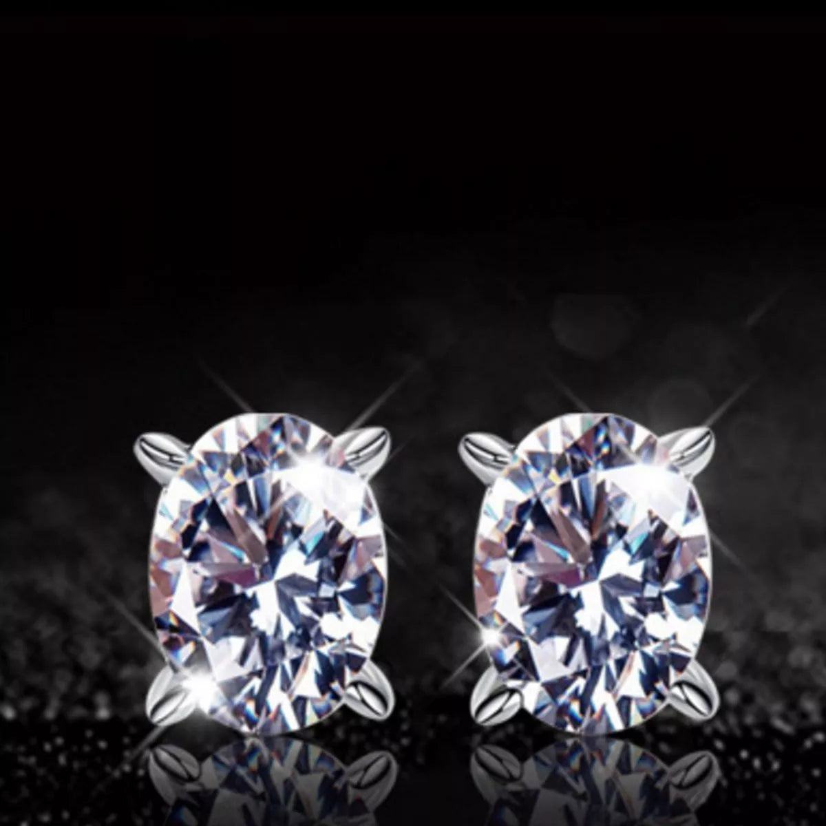 Silver-tone stud earrings with clear faceted stones — detail view
