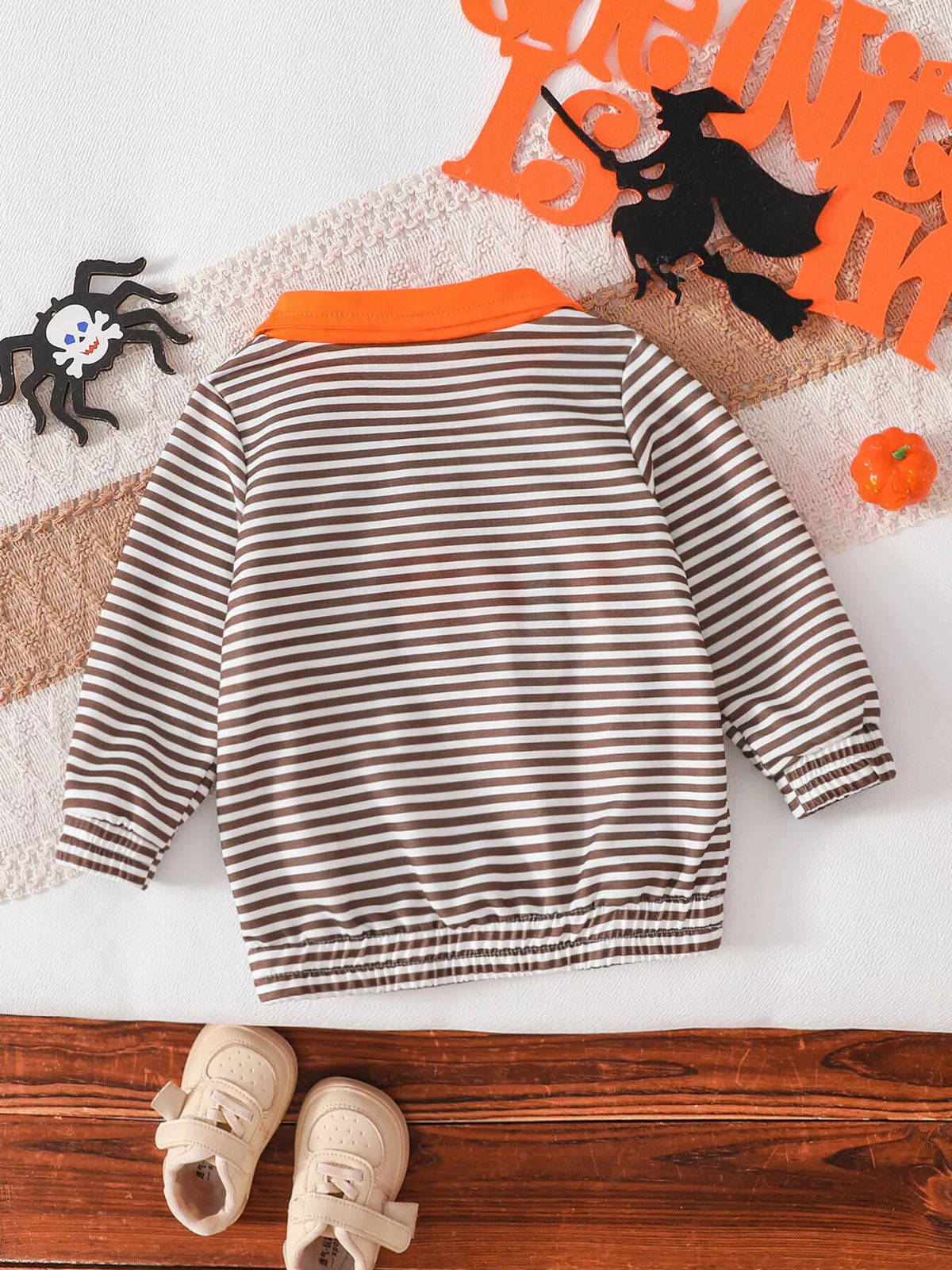 Back flat lay of the brown-and-white striped children's top.