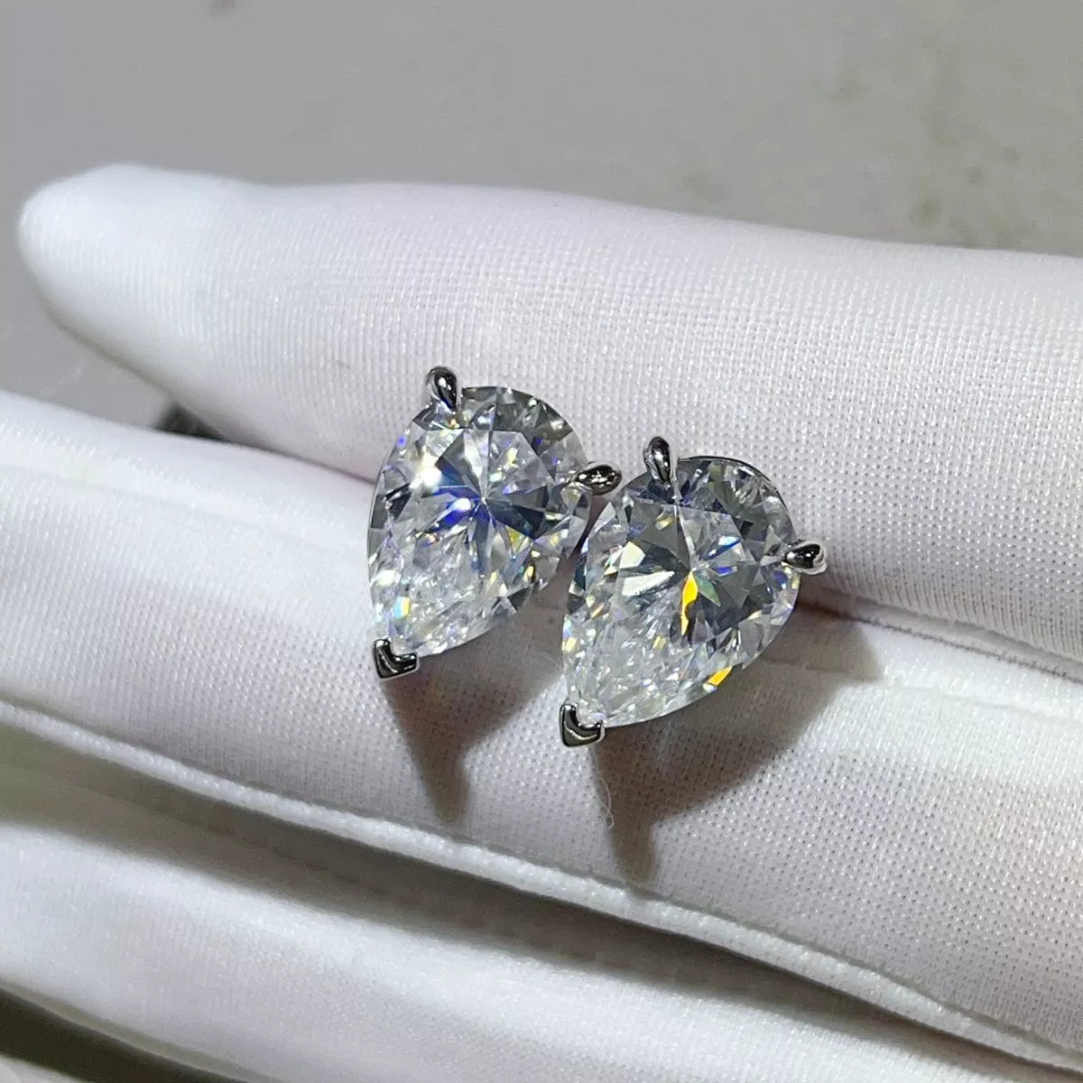 Silver-tone stud earrings with triangular clear stones — detail view