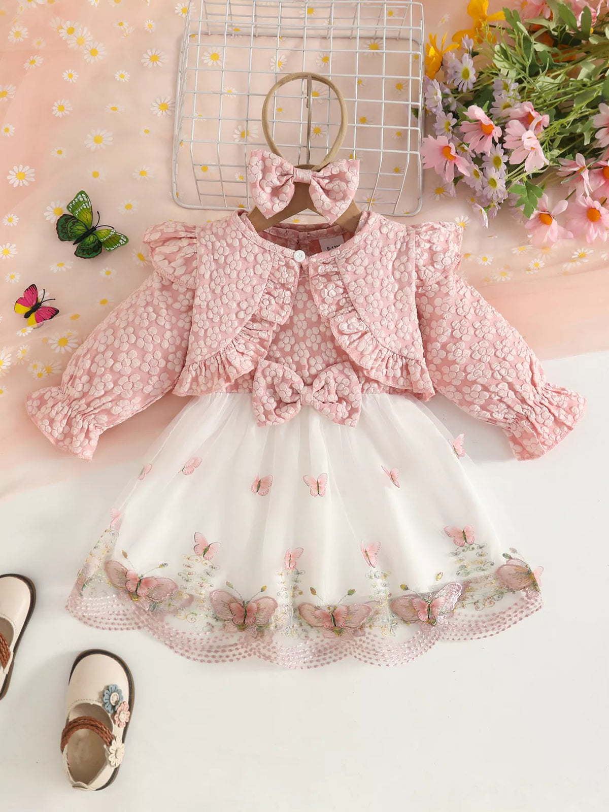 Blush floral baby outfit with cropped jacket, matching vest, white tulle skirt and bow headband.