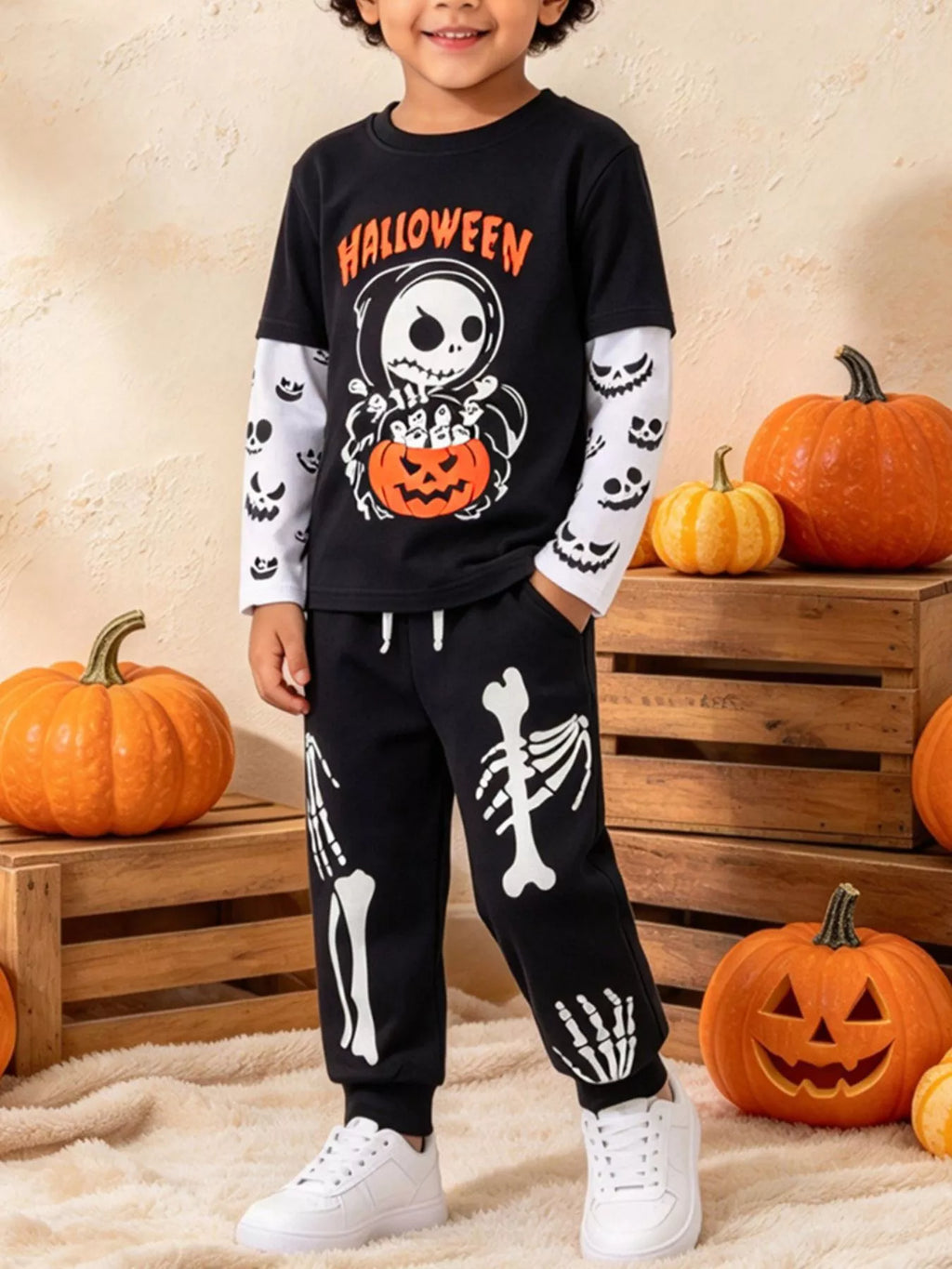 Children’s black Halloween skeleton graphic top and skeleton-print pants worn by a child