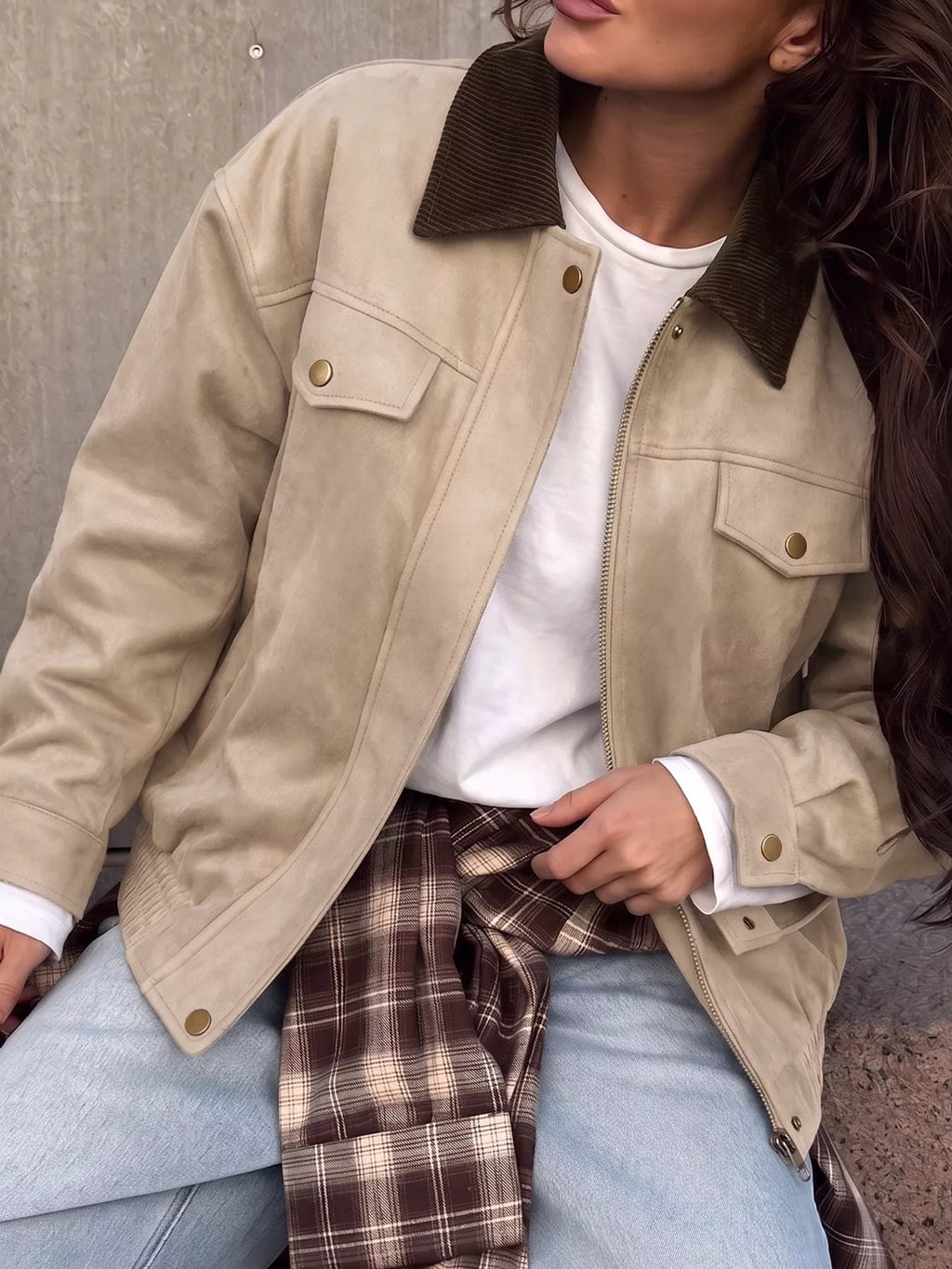 Close front view of the apricot jacket's collar and pockets.