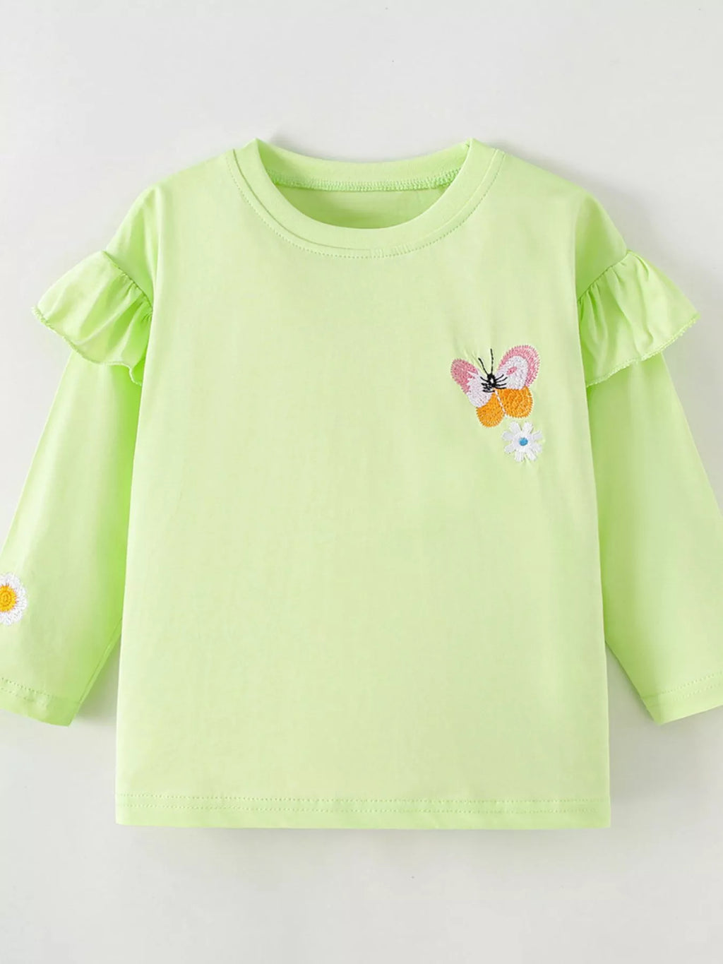 Front product view of the light green ruffle-shoulder butterfly top.
