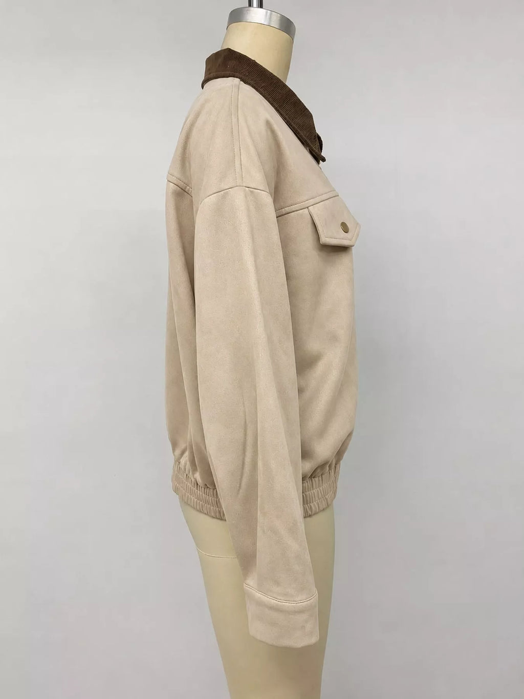 Side view of the apricot jacket on a mannequin.