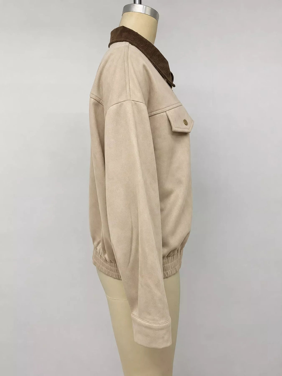 Side view of the apricot jacket on a mannequin.