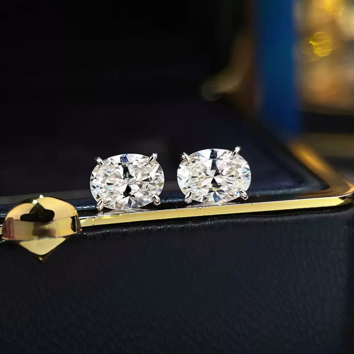 Silver-tone stud earrings with clear faceted stones — detail view