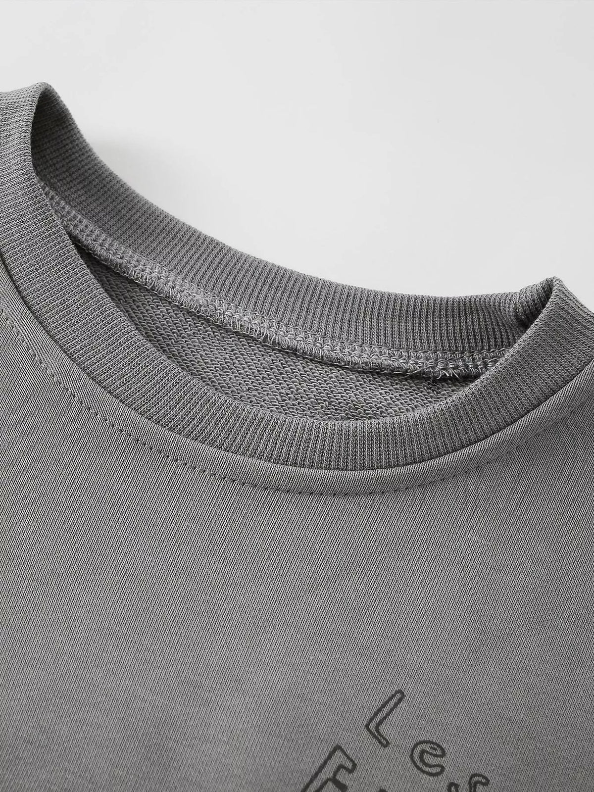 Gray ribbed crew neckline of the children’s sweatshirt