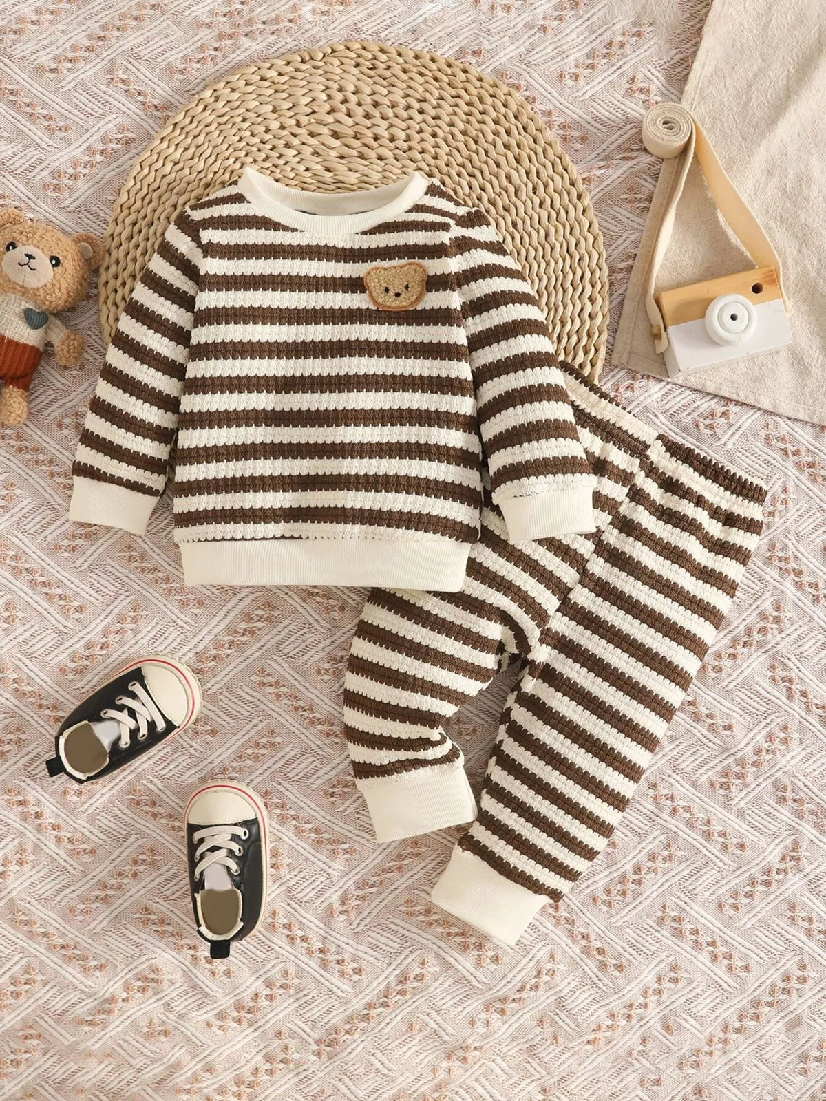 Brown and cream striped knit top and matching pants displayed flat