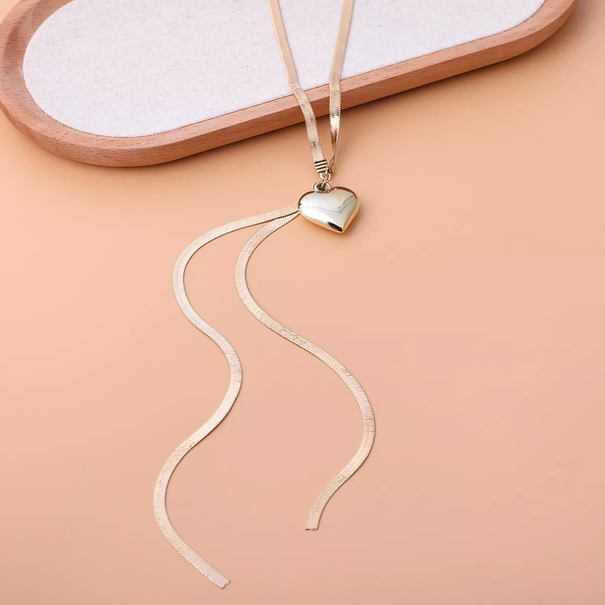 Gold-tone heart pendant lariat necklace with long chain tassels