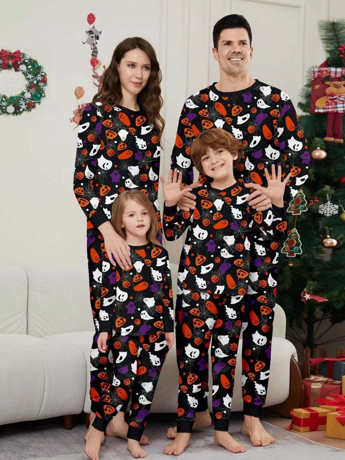 Black matching family pajamas with colorful Halloween ghost and pumpkin print worn by a family