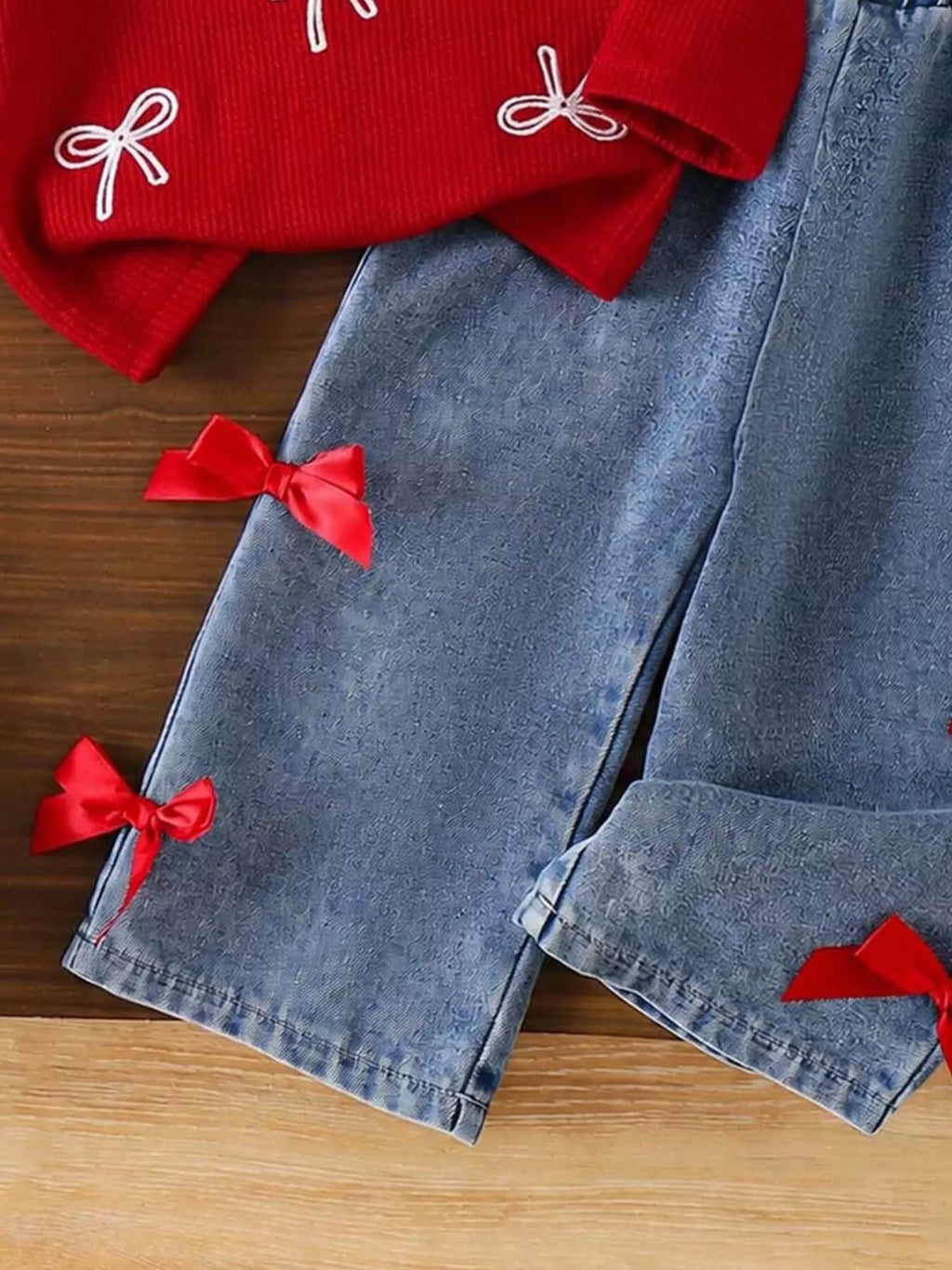 Red bow appliques on the blue jeans