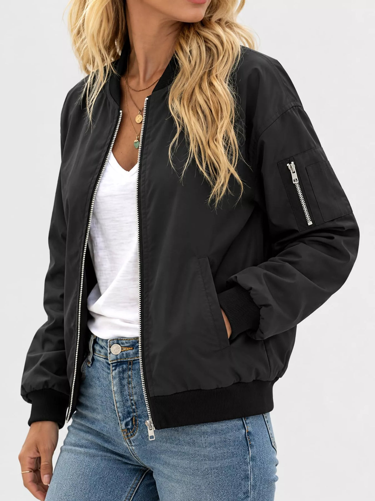 Black bomber jacket with ribbed trim, side pocket and zipped sleeve pocket.