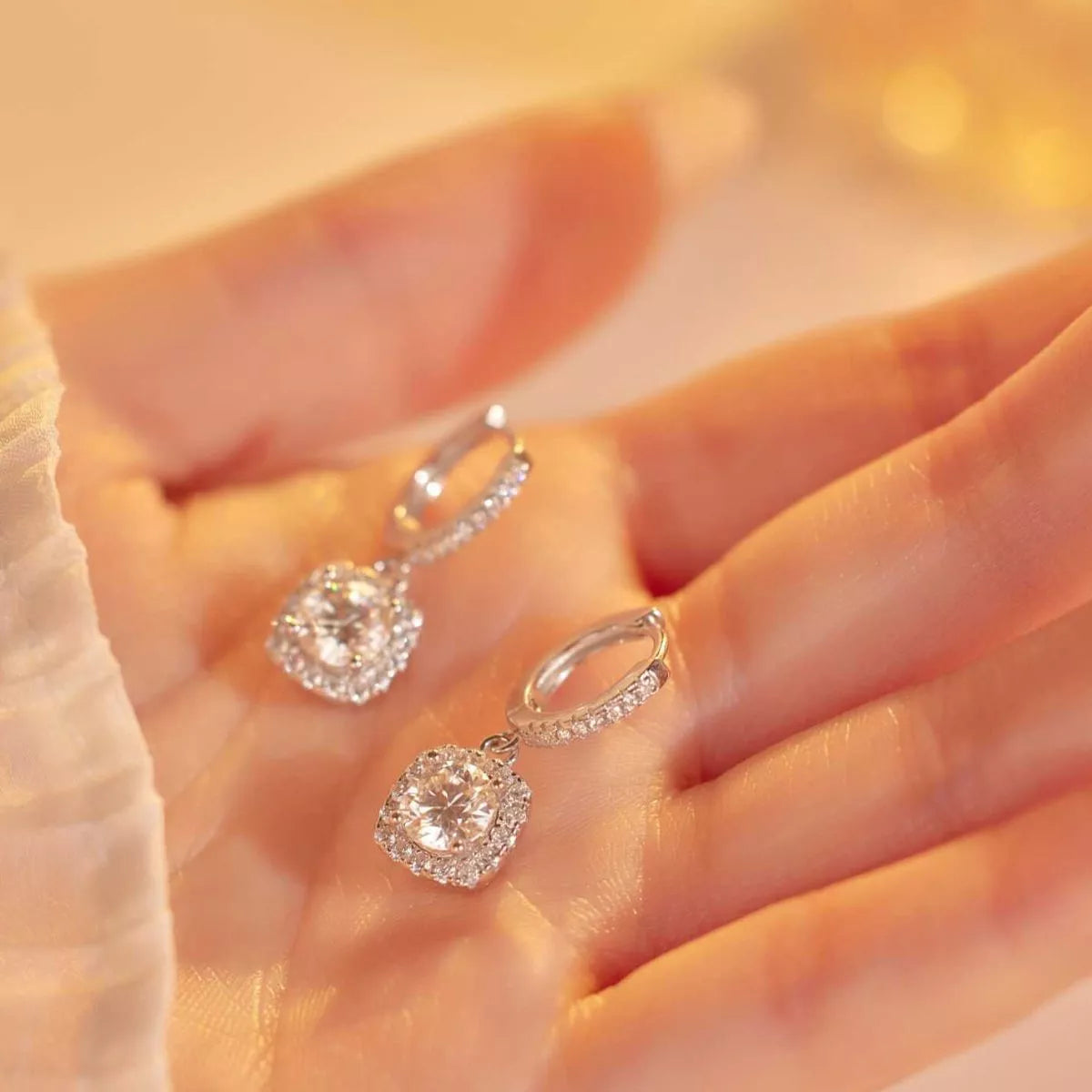 Silver-tone hoop earrings with square halo stone drops — detail view