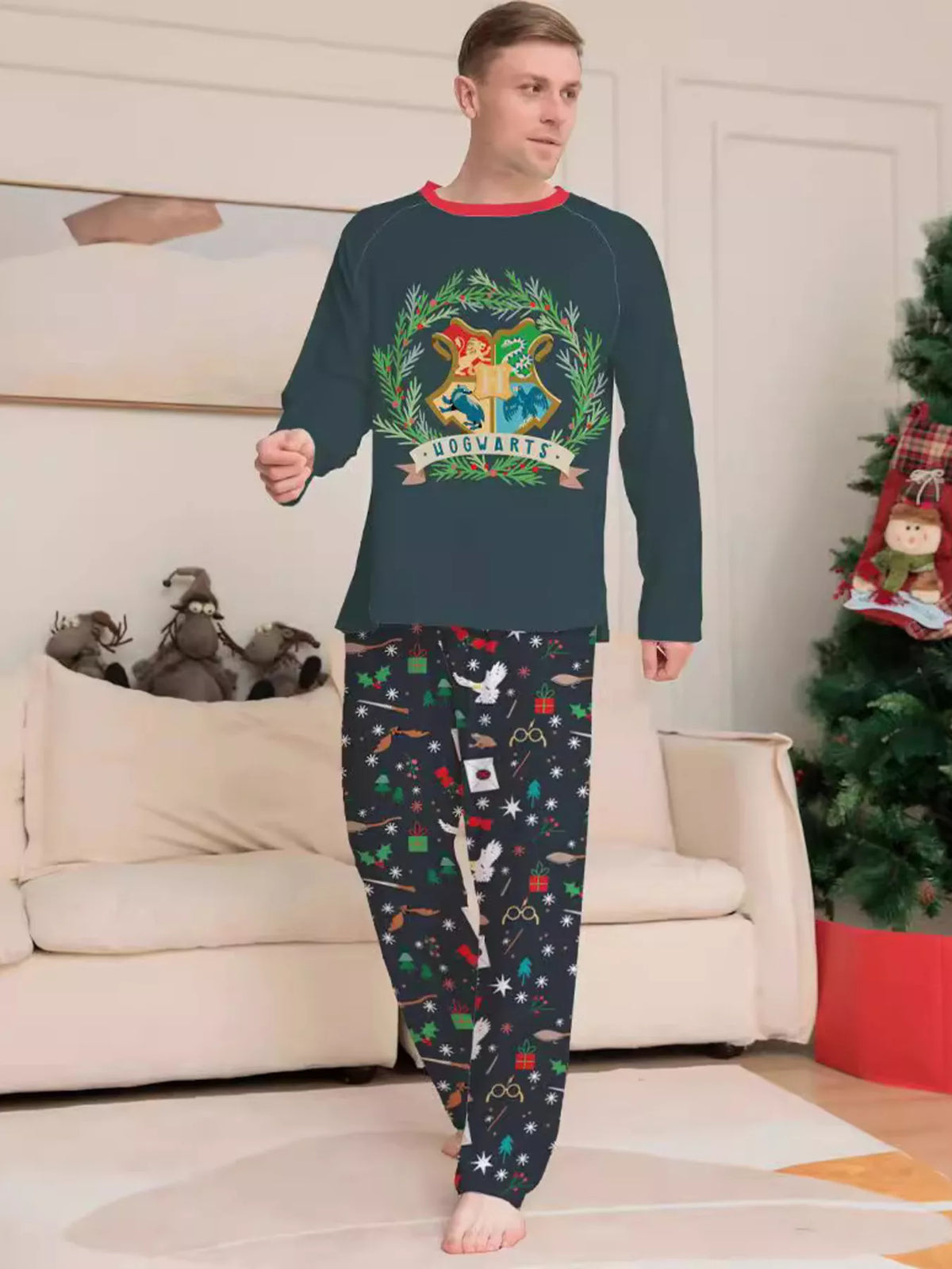 Dark green Hogwarts graphic pajama top with black patterned pants worn by an adult