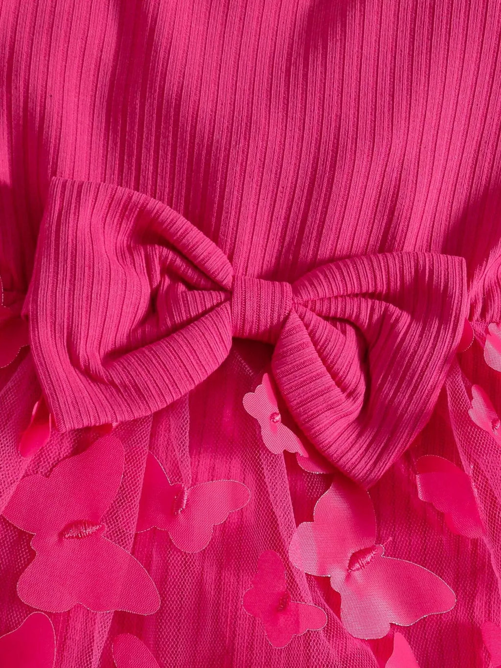 Large bow and ruffle trim on the hot pink ribbed baby bodysuit