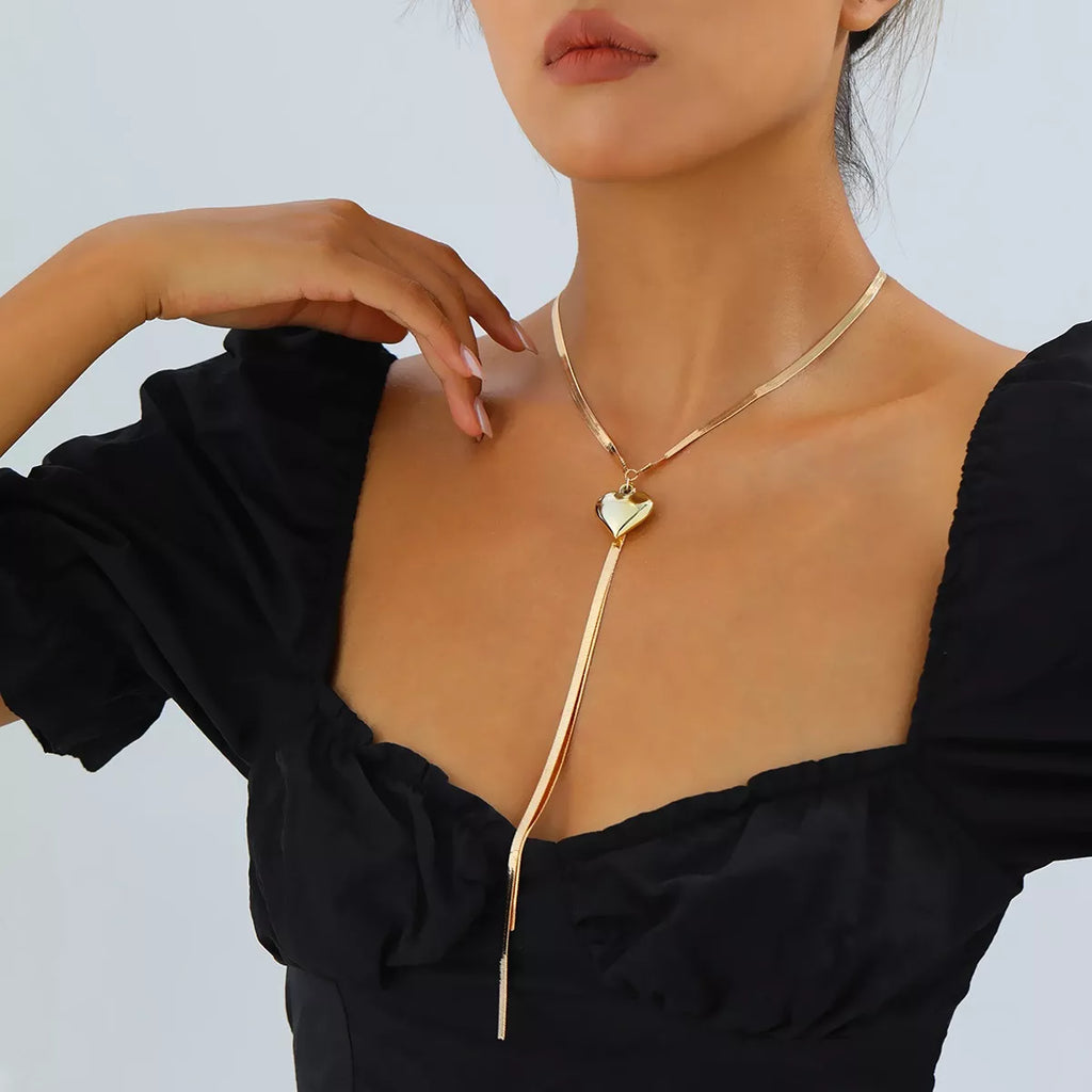 Gold-tone heart pendant lariat necklace with long chain tassels