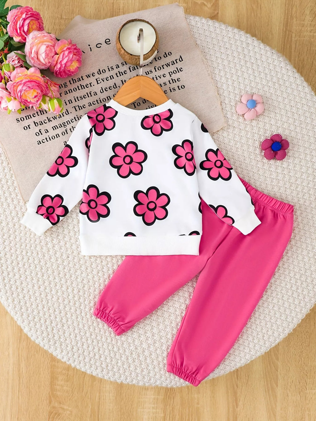Back flat lay of the pink-flower sweatshirt and bright pink pants.