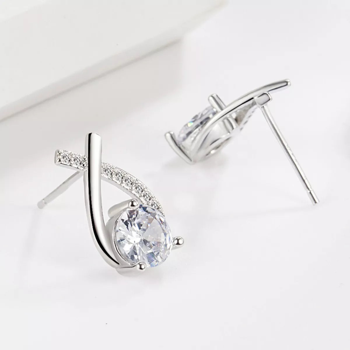 Silver-tone open teardrop earrings with round clear stones — detail view