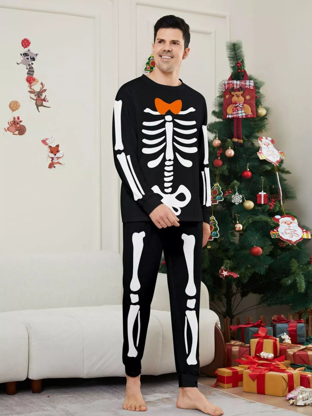 Man posing in the black and white skeleton-print pajama set.
