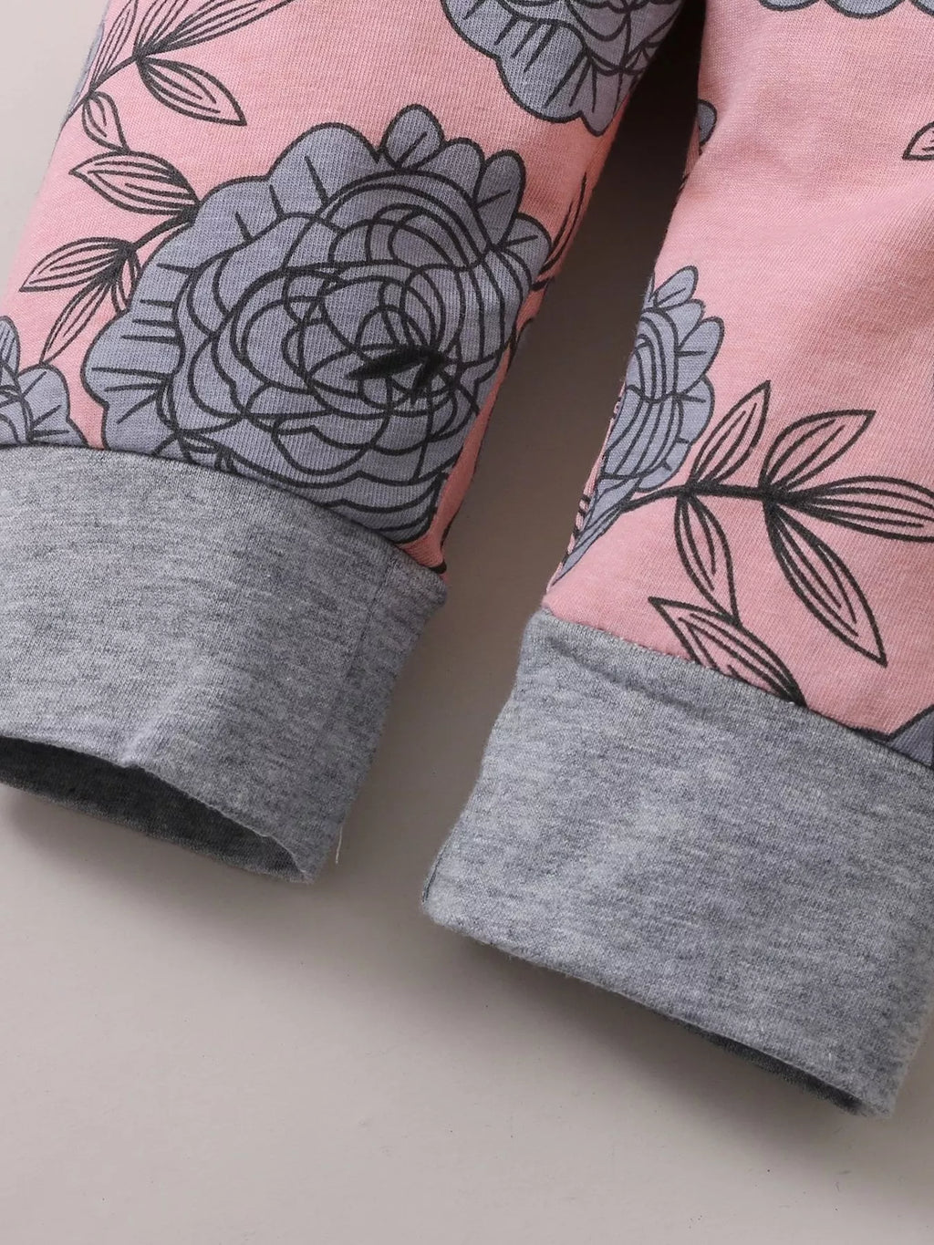 Gray cuffs and floral print on the pink baby pants