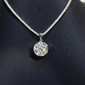 Silver-tone necklace with a round clear stone pendant — detail view