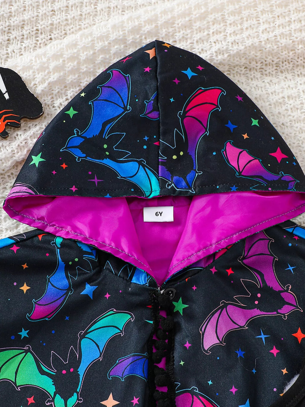 Close-up of the colorful bat-print cape hood and purple lining.
