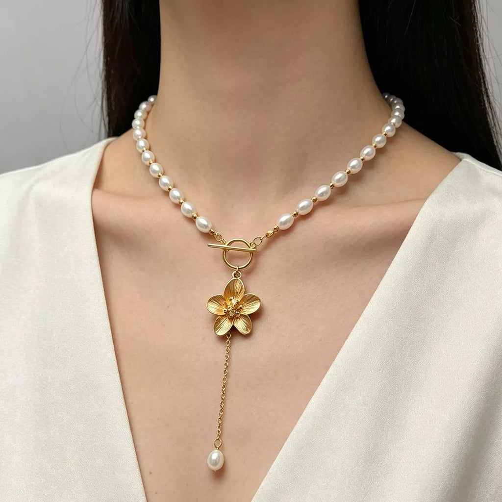 Pearl-like bead choker with gold-tone flower clasp and long pendant