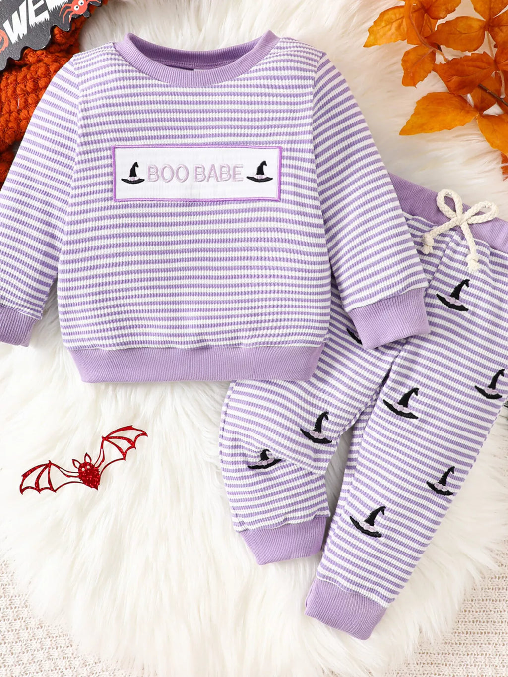 Purple striped BOO BABE pajama top and matching Halloween-print pants displayed flat