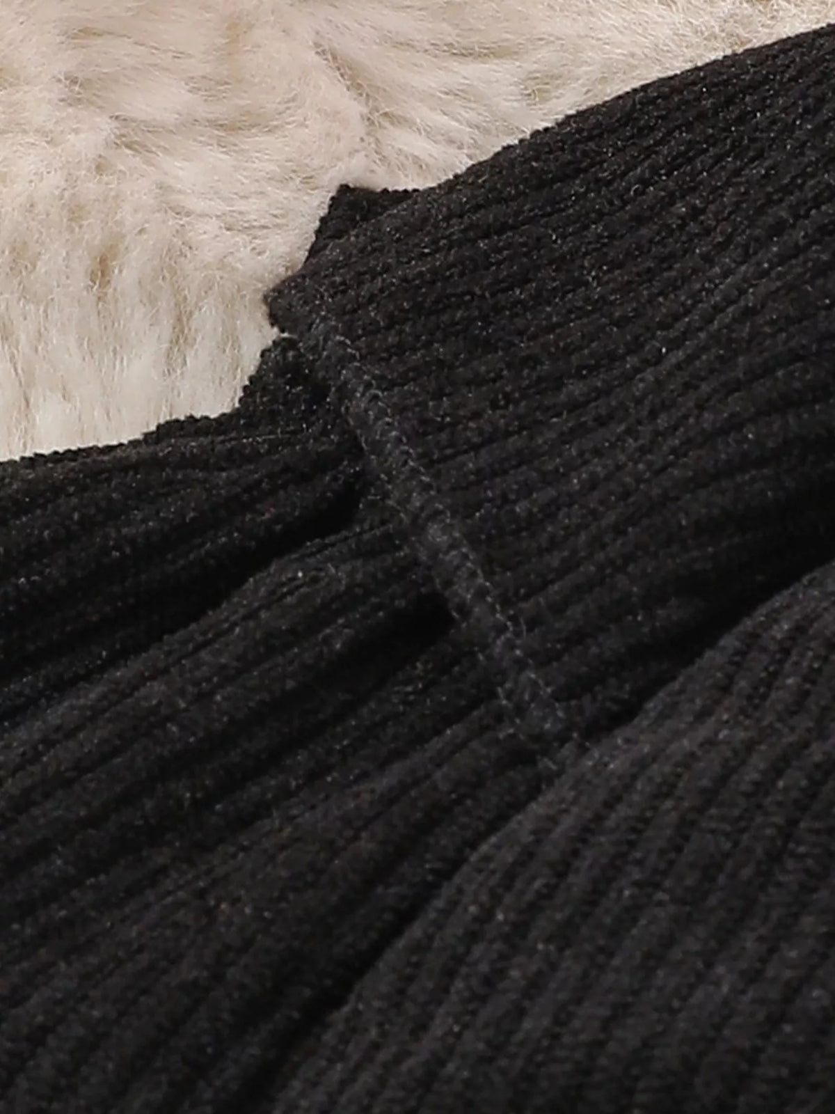 Black ribbed ruffle detail on the baby bodysuit