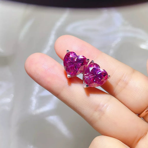 Pink heart-shaped gemstone stud earrings — detail view