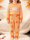Orange striped BOO BABE pajama top and matching Halloween-print pants worn by a child
