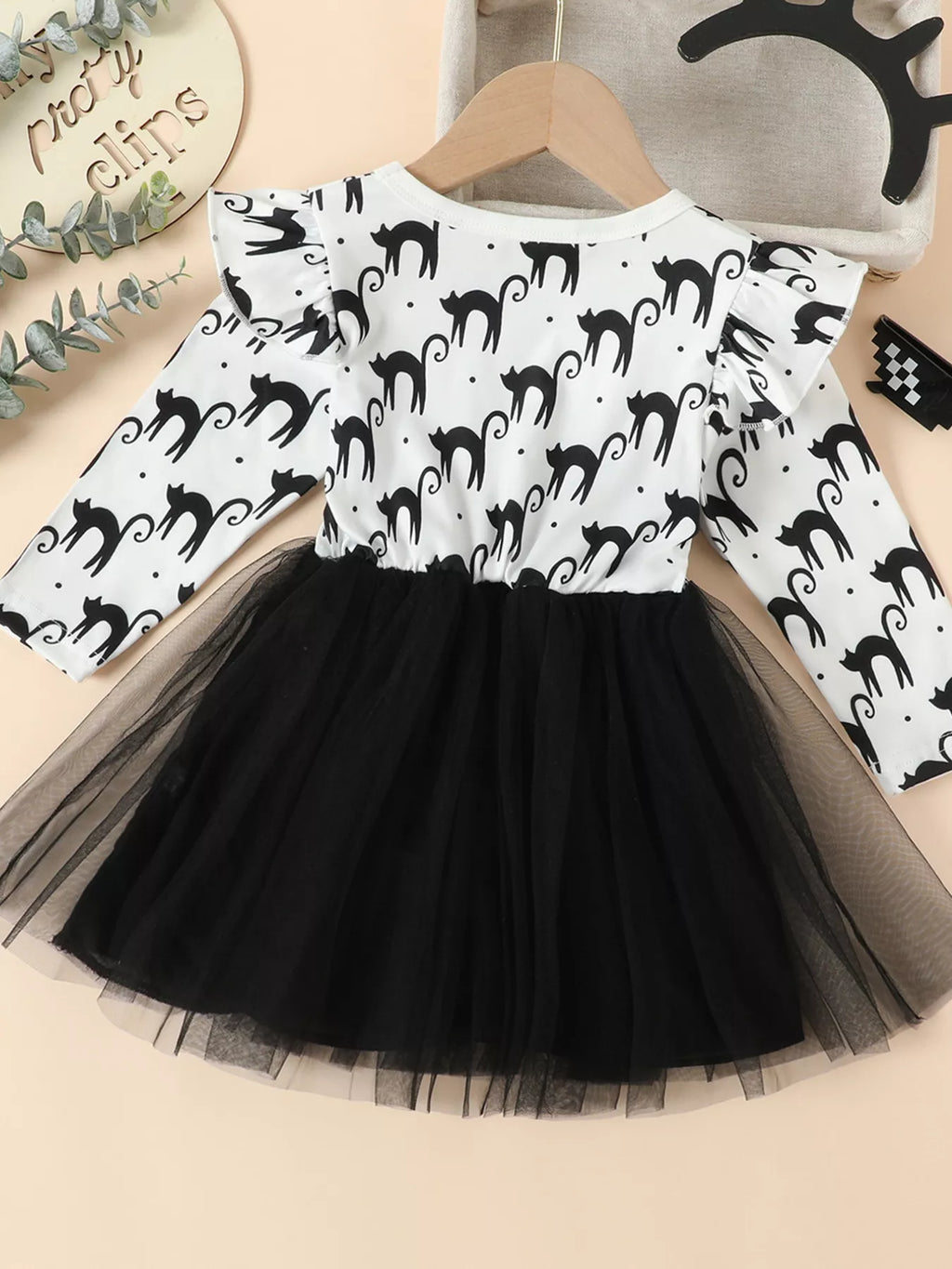 Back view of the white black-cat-print long-sleeve dress with black tulle skirt.