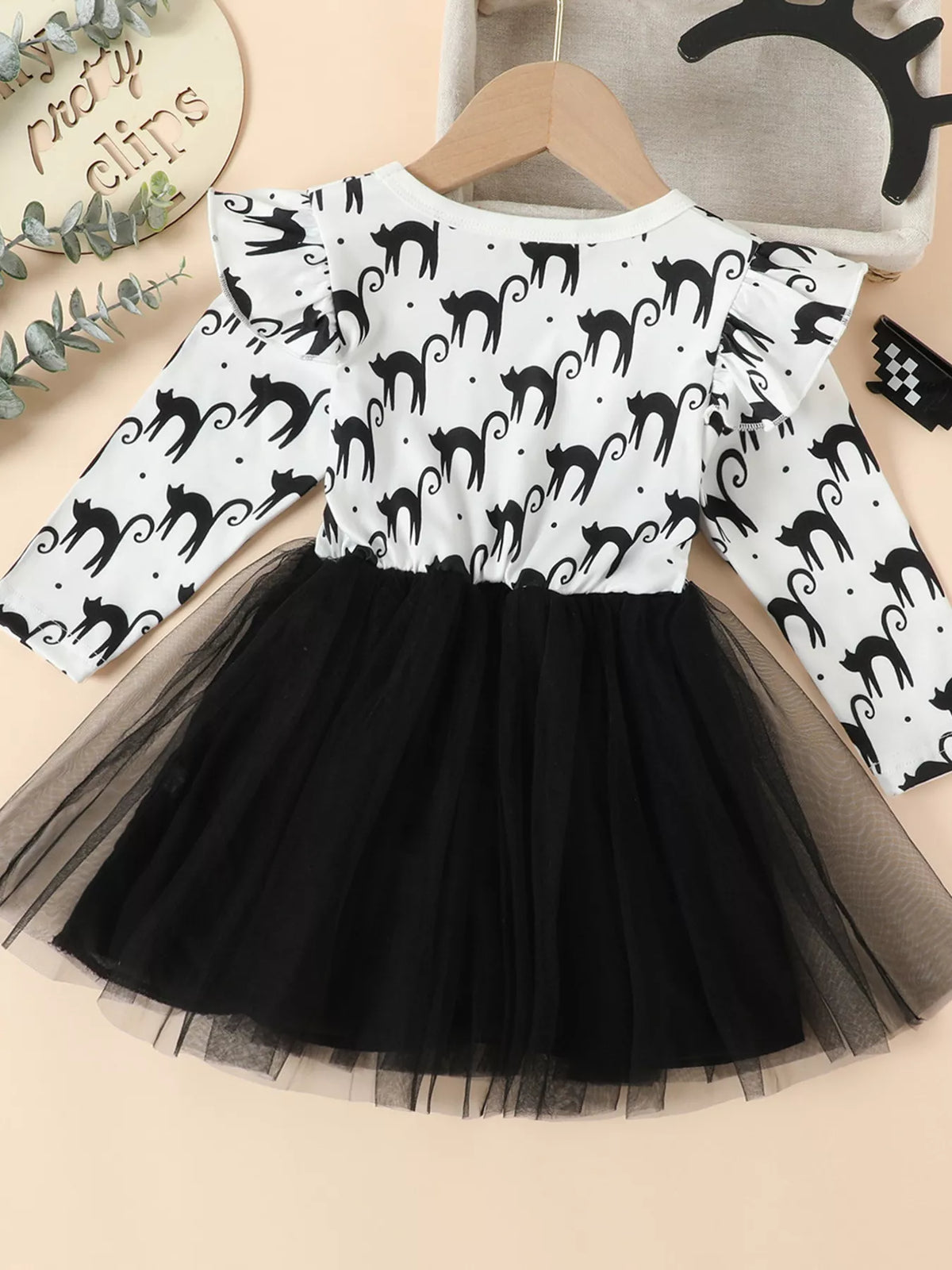 Back view of the white black-cat-print long-sleeve dress with black tulle skirt.