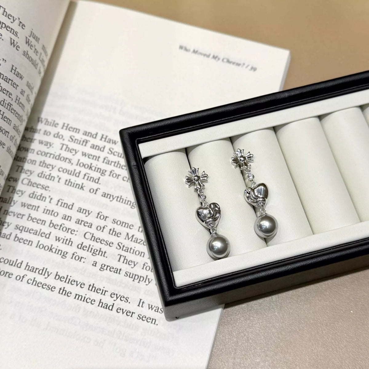 Heart-shaped drop earrings with gray pearl-like beads