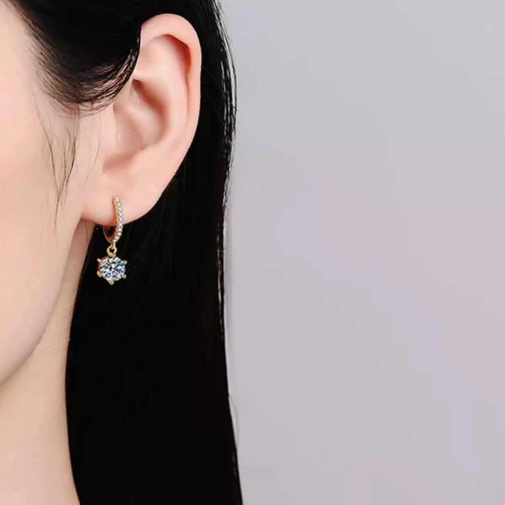 Gold-tone hoop earrings with round clear stone drops — detail view