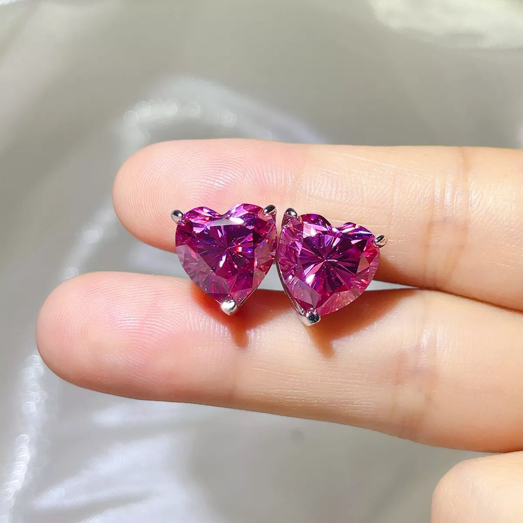 Pink heart-shaped gemstone stud earrings — detail view