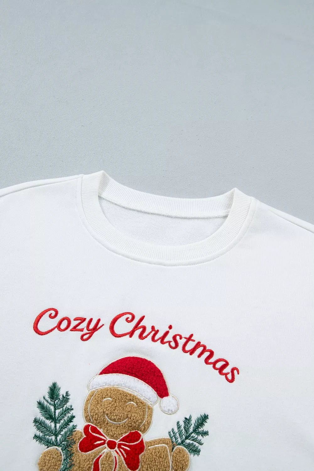 White embroidered Gingerbread Cozy Christmas Long Sleeve Round Neck Sweatshirt — detail view