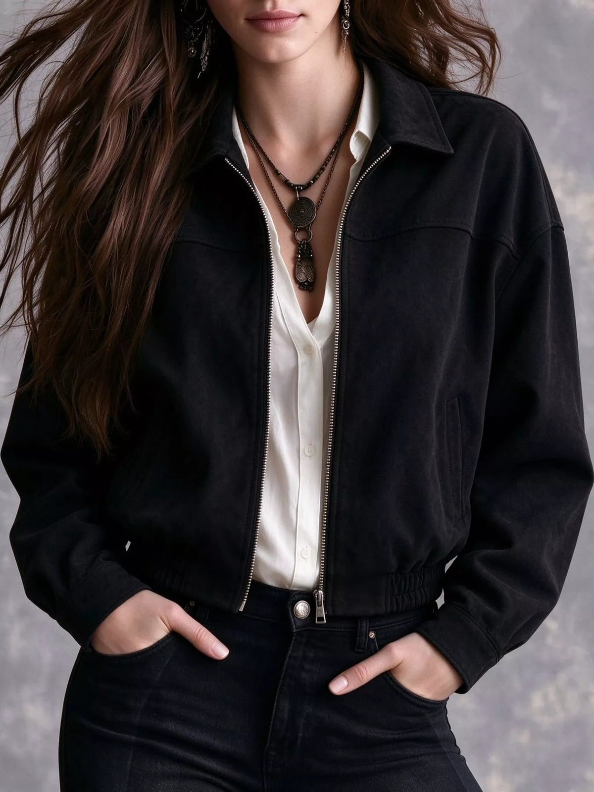 Front view of the black bomber jacket and gathered hem.