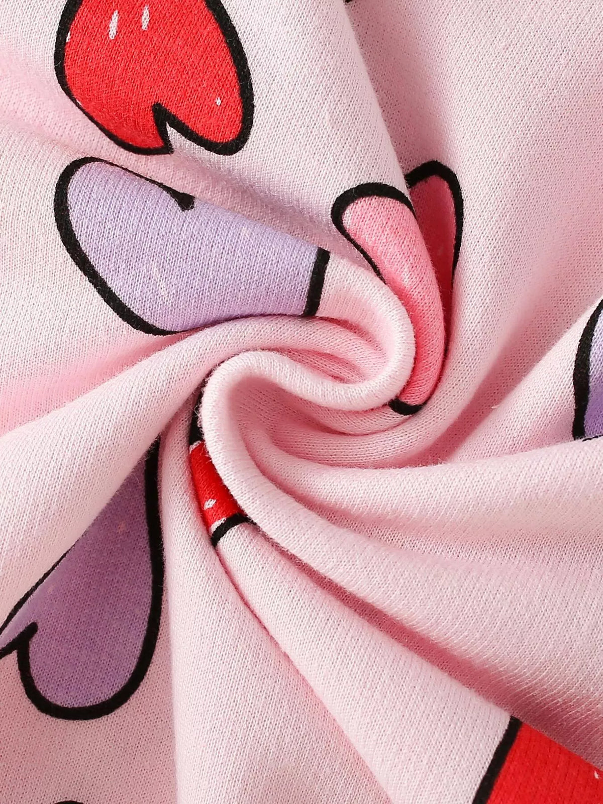 Pink fabric with red, white and black outlined heart shapes