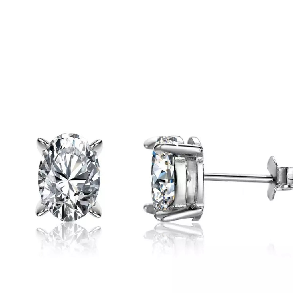 Silver-tone stud earrings with clear faceted stones — detail view
