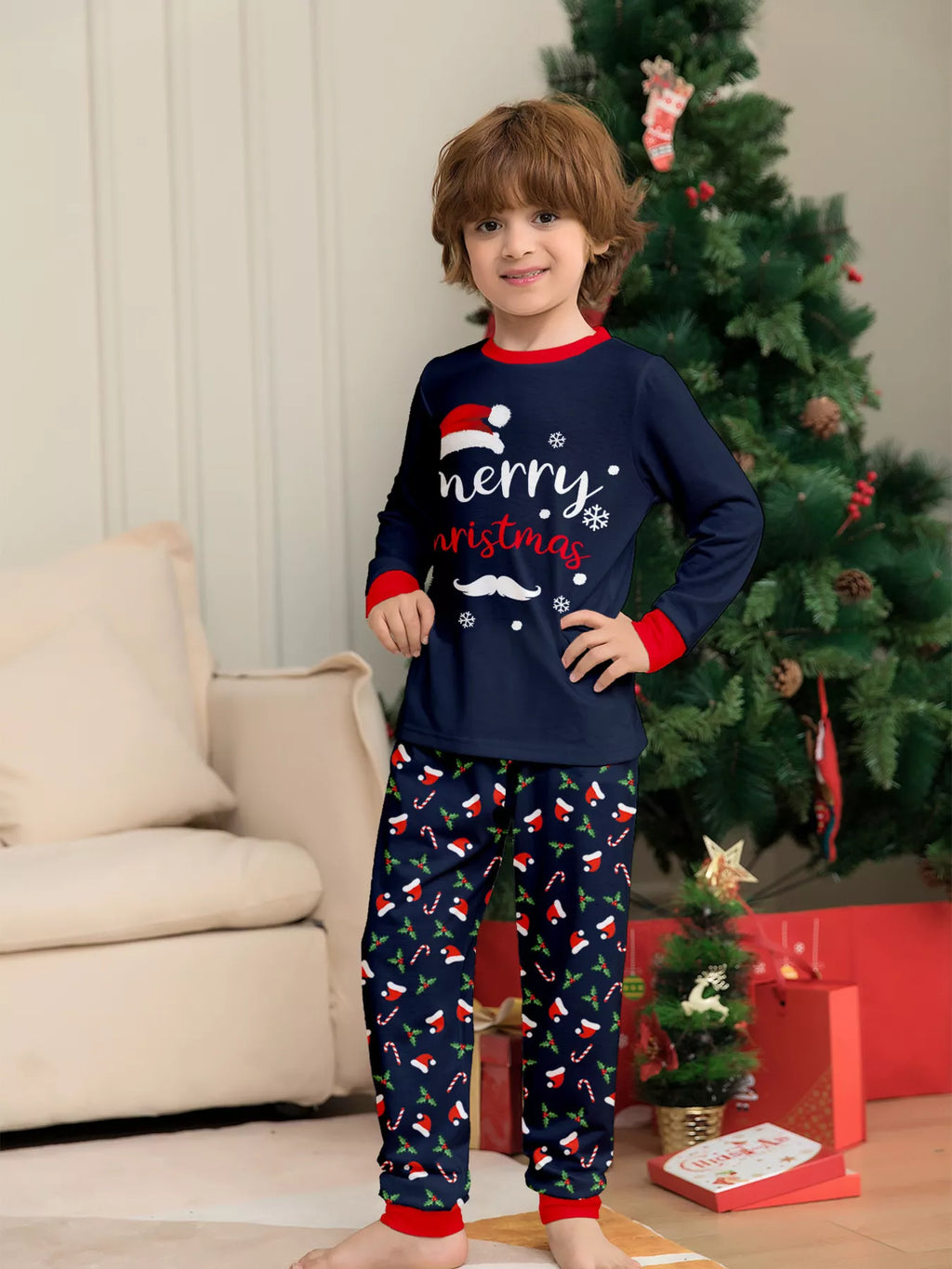 Child modeling the navy Merry Christmas top and festive pajama pants.