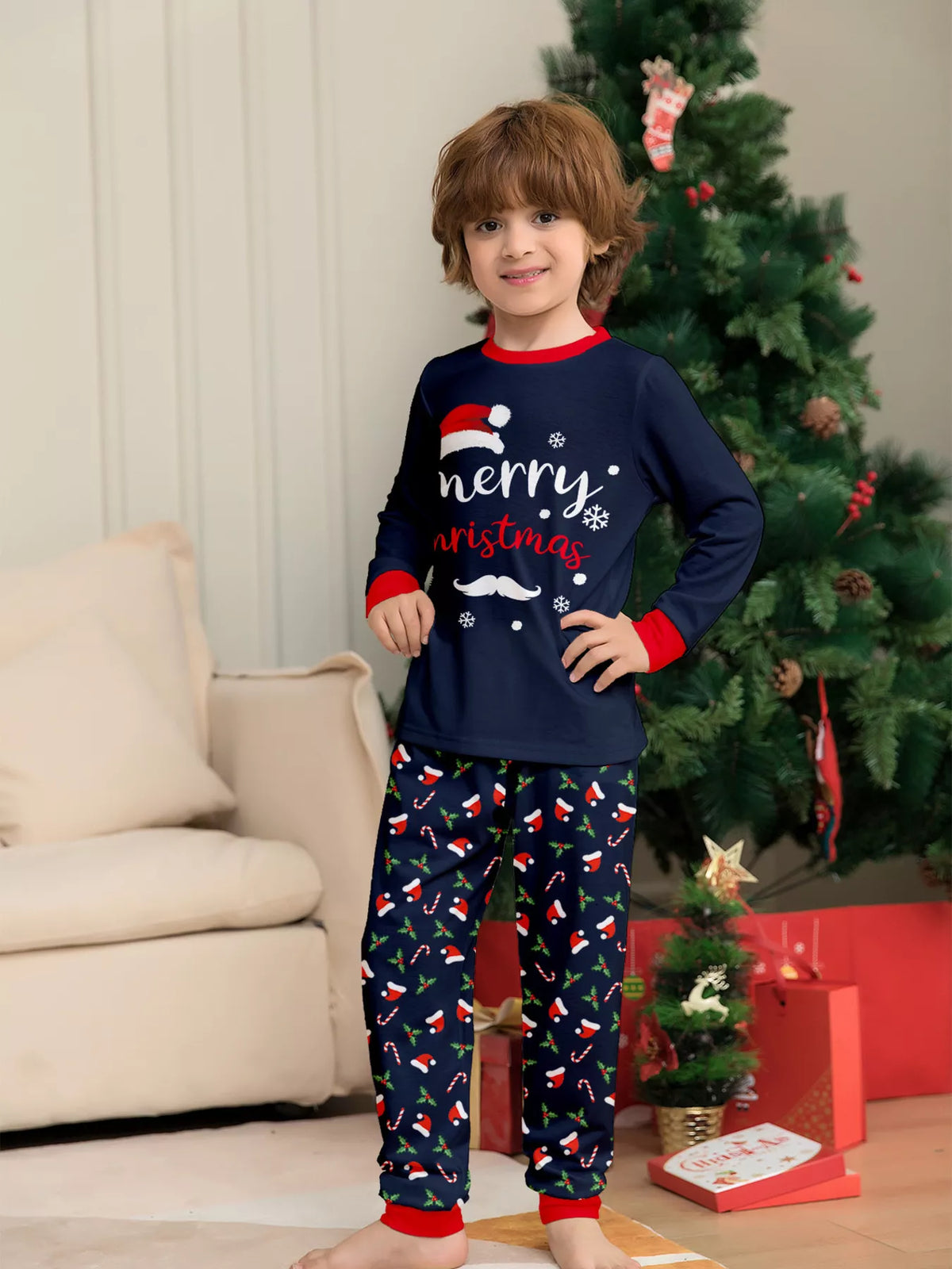 Child modeling the navy Merry Christmas top and festive pajama pants.