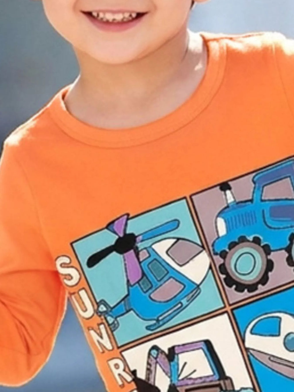 Close view of the orange shirt's neckline and vehicle graphic panel.