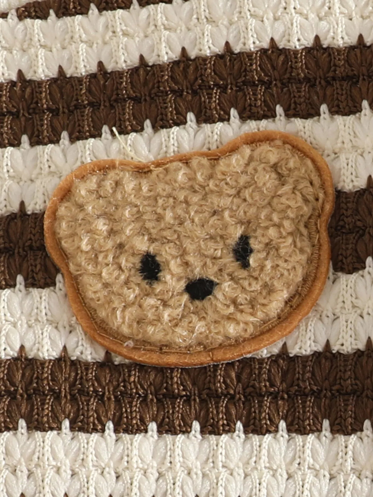 Bear-face patch on brown and cream striped knit fabric